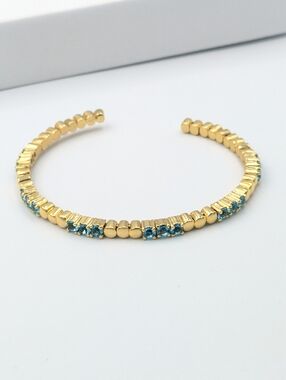 4/24$  Gold tone and blue rhinestone bangle bracelet